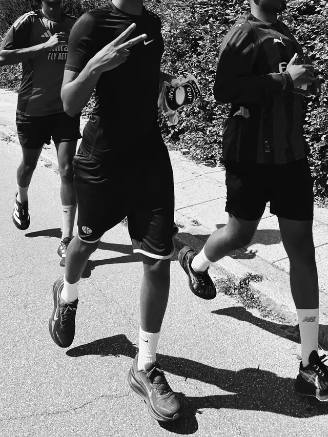 The legs of runners in stride