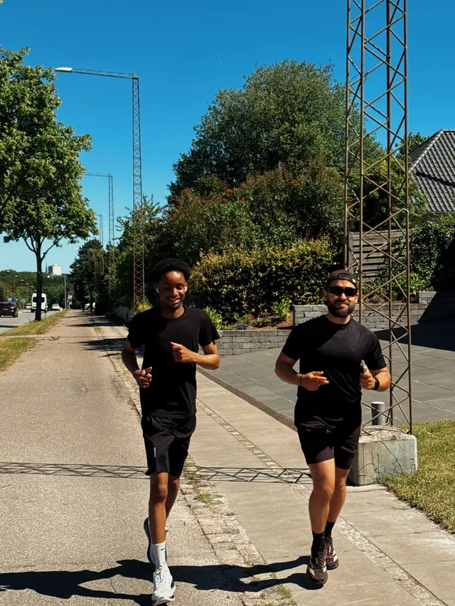 Two runners on a sunny road