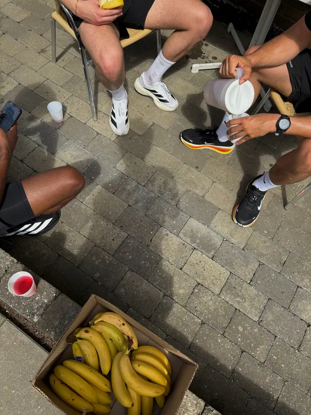 Coffee cups and running shoes seen from above