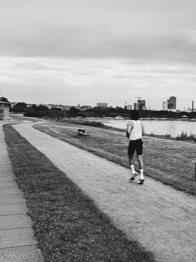 A lone runner by the water