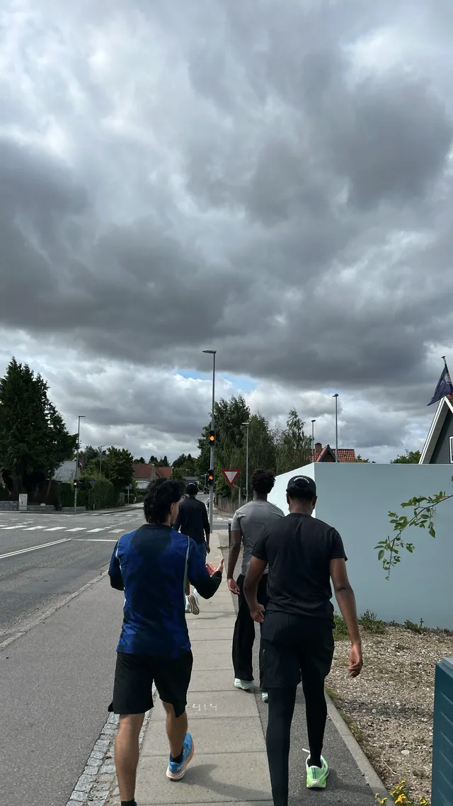 Running through the suburbs under a heavy sky