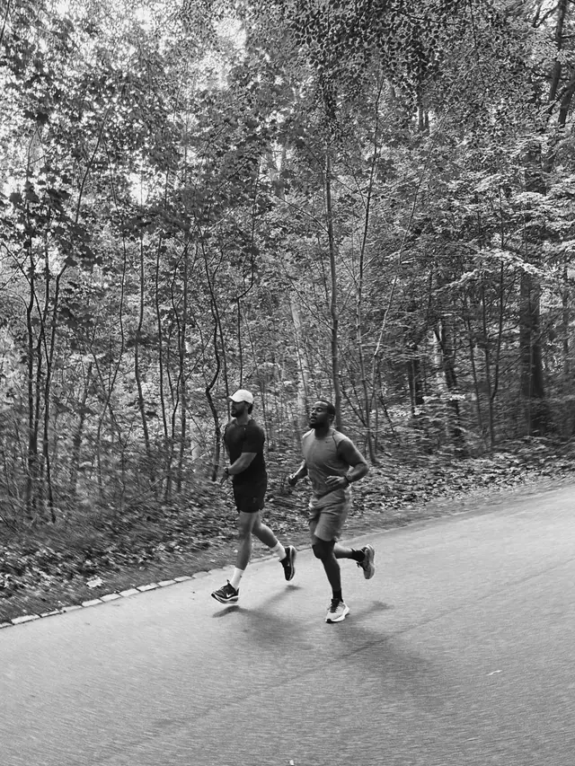 Two runners on a forest road