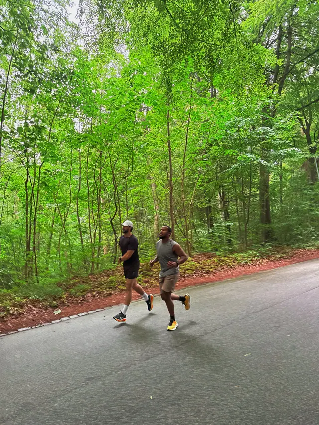 Two runners on a rainy road