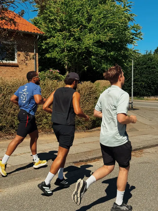 Three runners on a suburban street